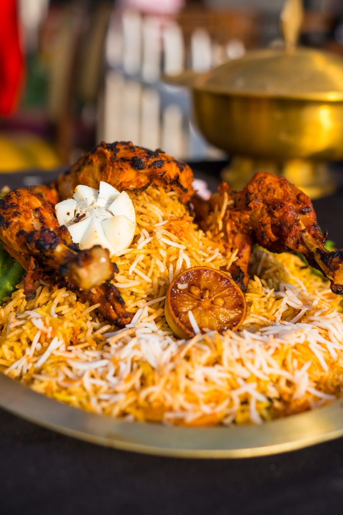 Services Savor the flavors of traditional Indian biryani with tender grilled chicken in this mouthwatering food photography shot.