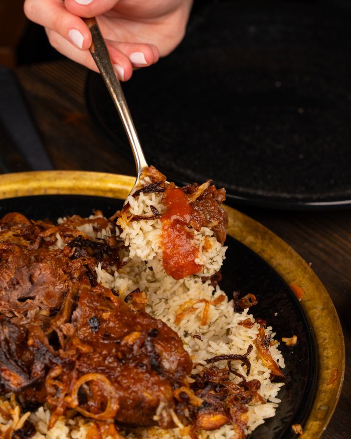 Services A savory spiced lamb dish paired with rice and tomatoes. Perfect for gourmet dinners.